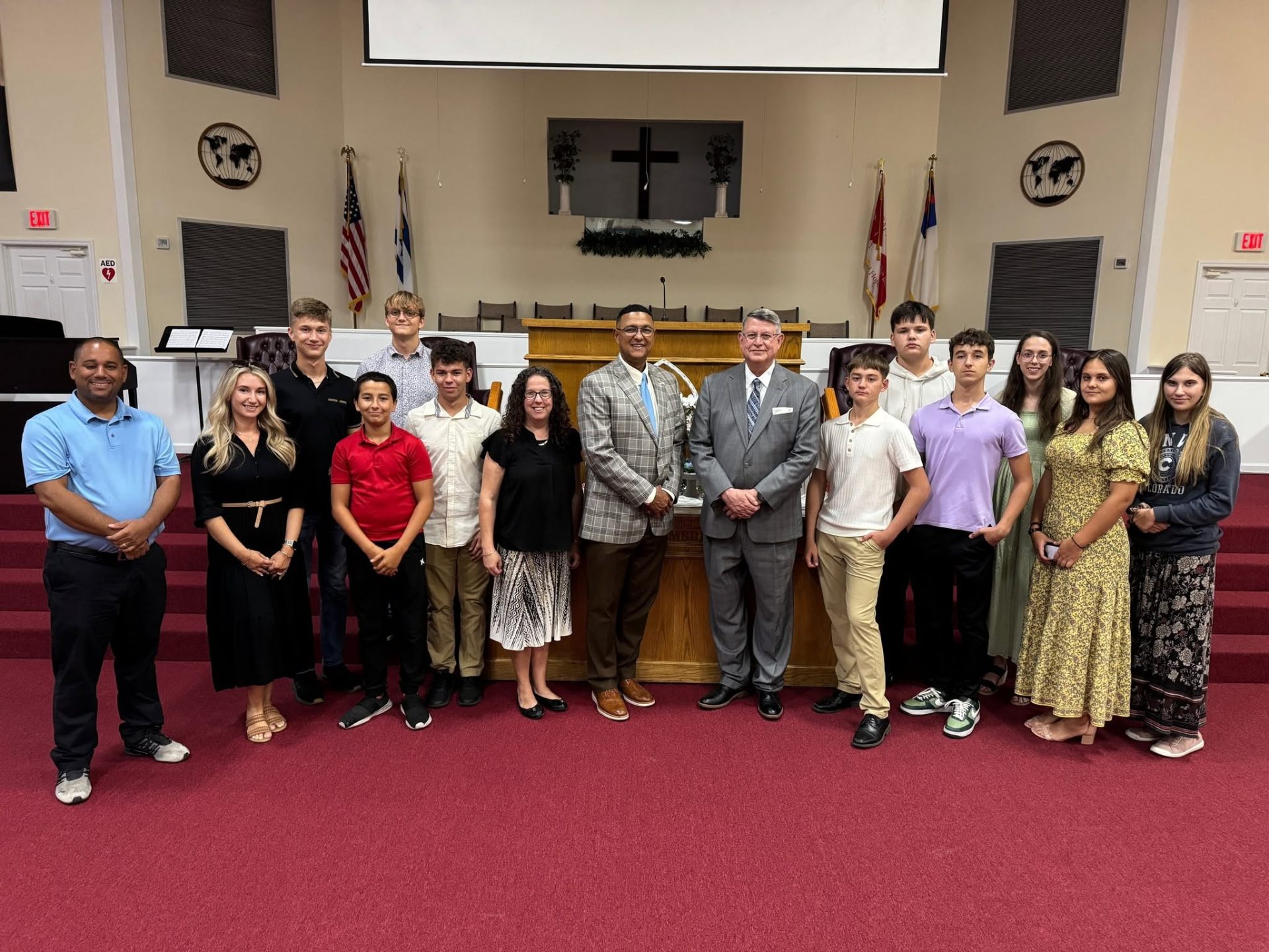 Victory Baptist Academy students and staff standing together in the church auditorium