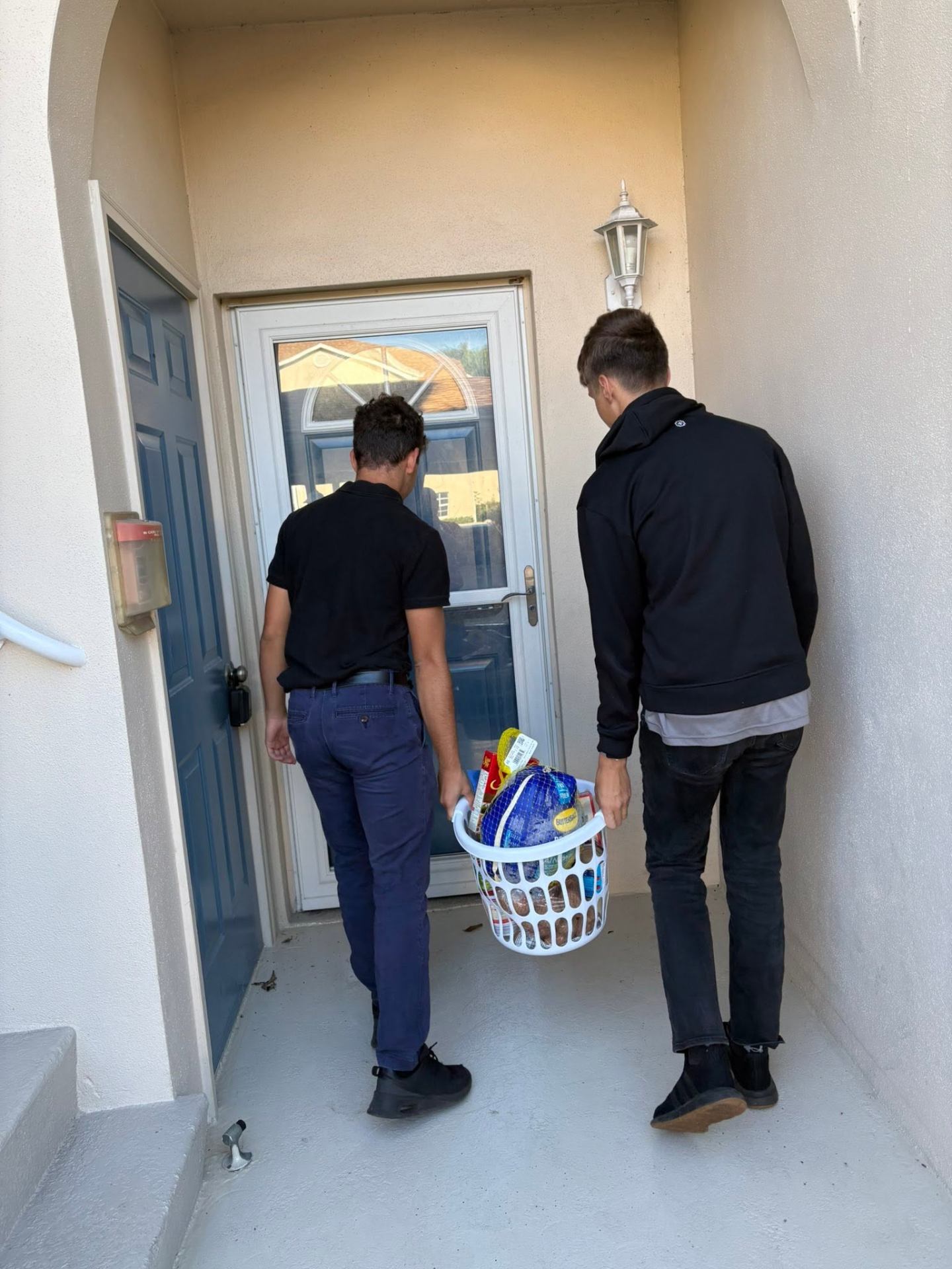 VBA students delivering Thanksgiving food baskets to a home